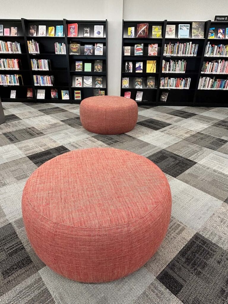 Well placed Pebble ottomans create reading zones and encourage browsing.