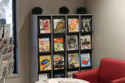 Magazine Display - Lift and retract doors showcase front faced current edition while back issues are neatly stored in pigeon holes
